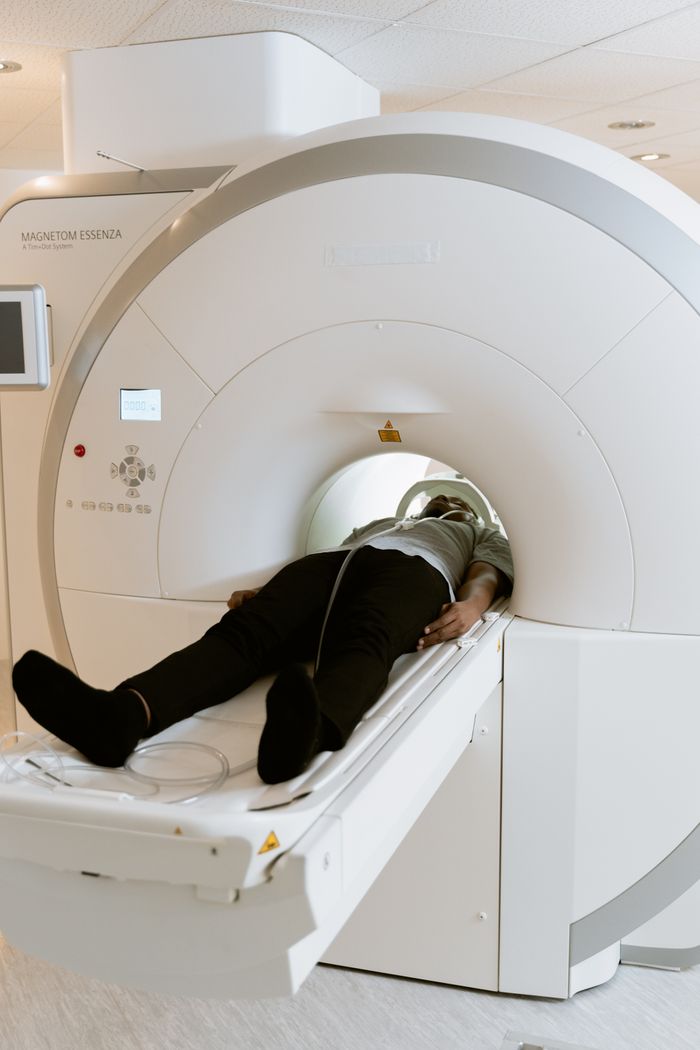 A person undergoing an MRI screening — photo by MART PRODUCTION on Pexels