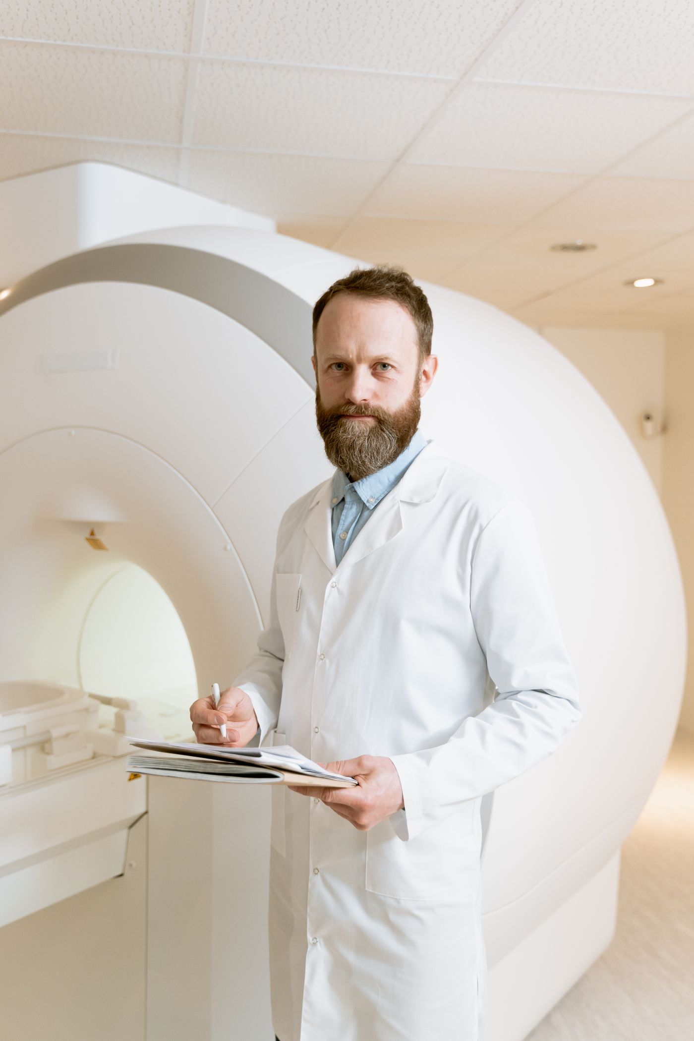 Medical professional beside advanced imaging equipment