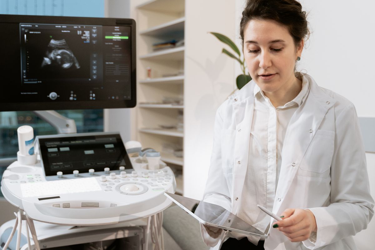 Female clinician reviewing medical scans for persistent fatigue