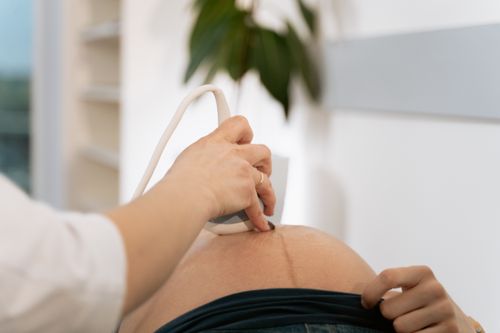 Free A close-up of a healthcare professional conducting an ultrasound on a pregnant woman. Stock Photo