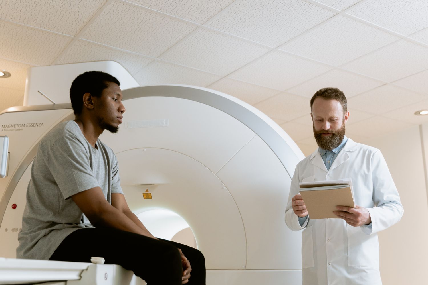 Medical consultation next to advanced imaging equipment