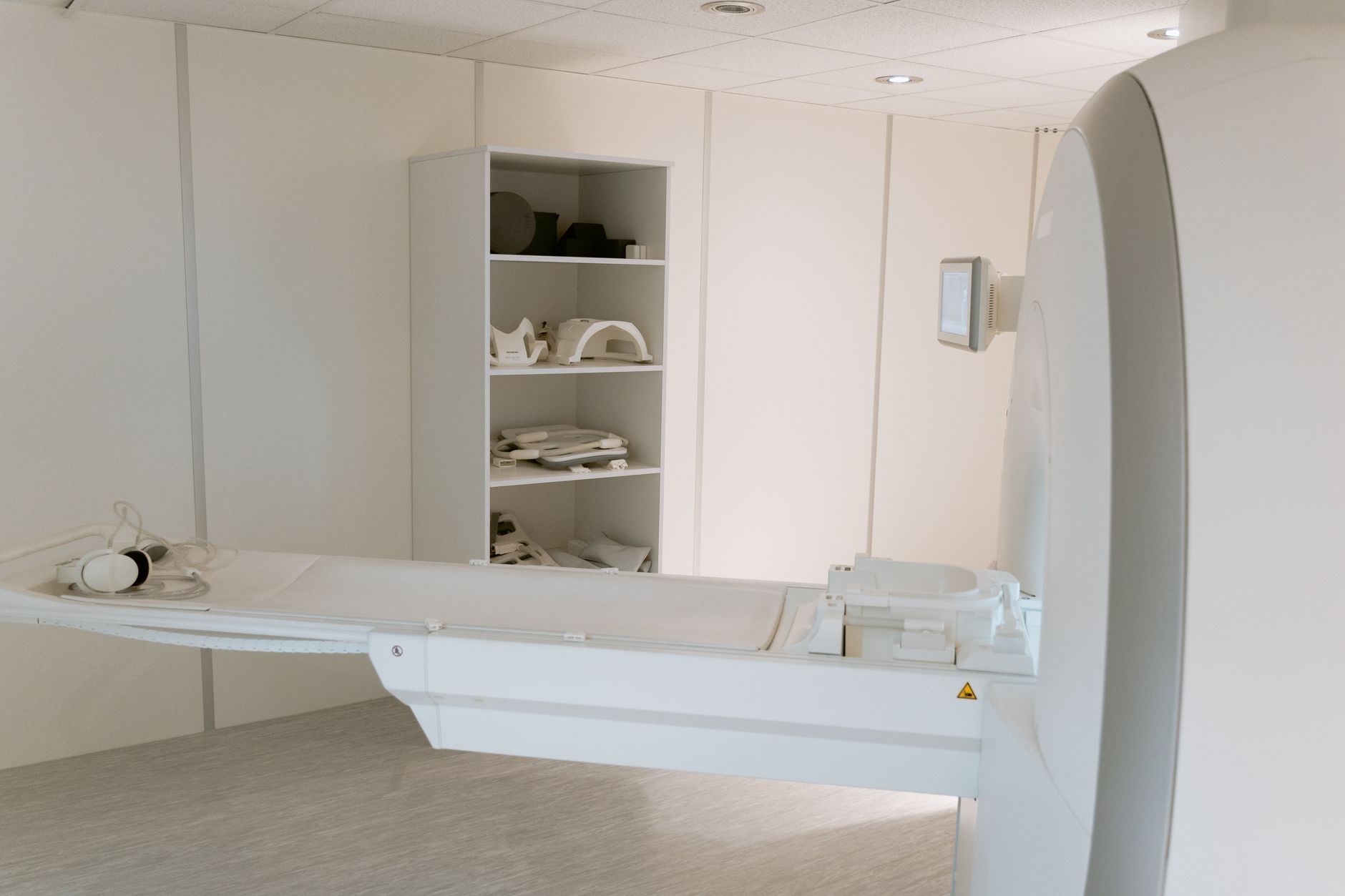 A modern CT scanning machine in a hospital imaging room, ready for patient examination.