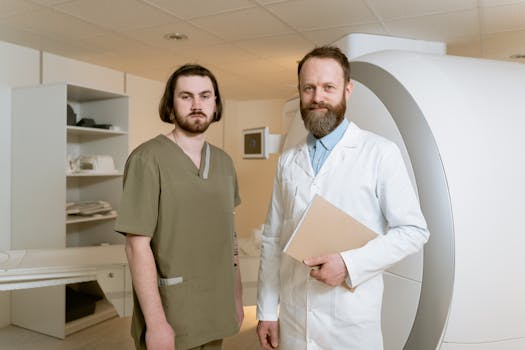 Two male radiologists standing by an MRI scanner in a medical facility, showcasing expertise and professionalism.