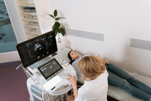 Photo Of Gynecologist Doing An Ultrasound Test On A Pregnant Woman
