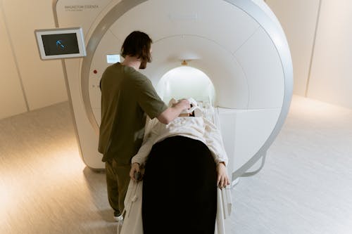 Photo Of Radiologist Operating The CT Scanner 