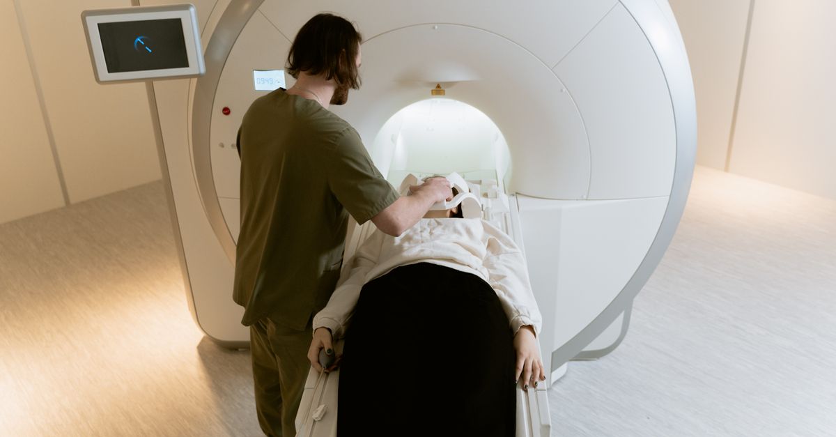 Photo Of Radiologist Operating The CT Scanner · Free Stock Photo
