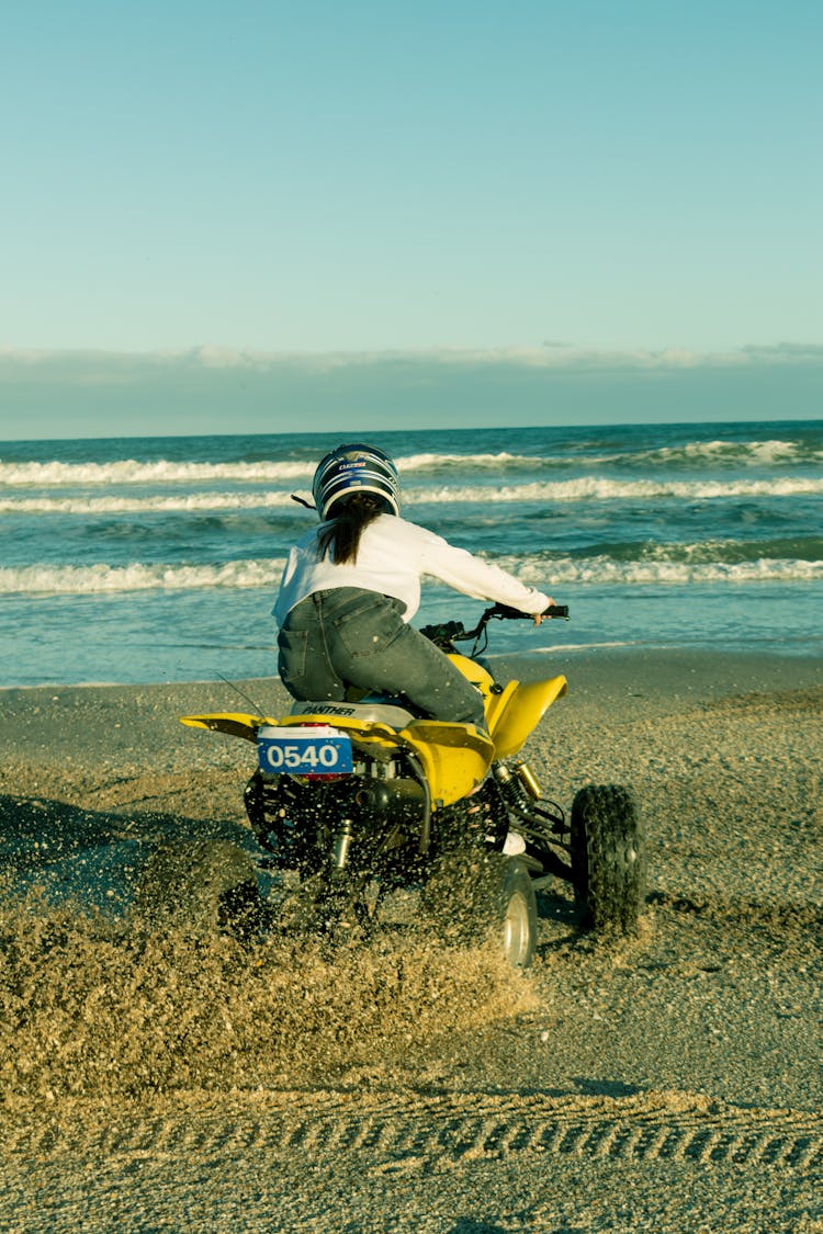 A Person Riding An Atv On The Beach