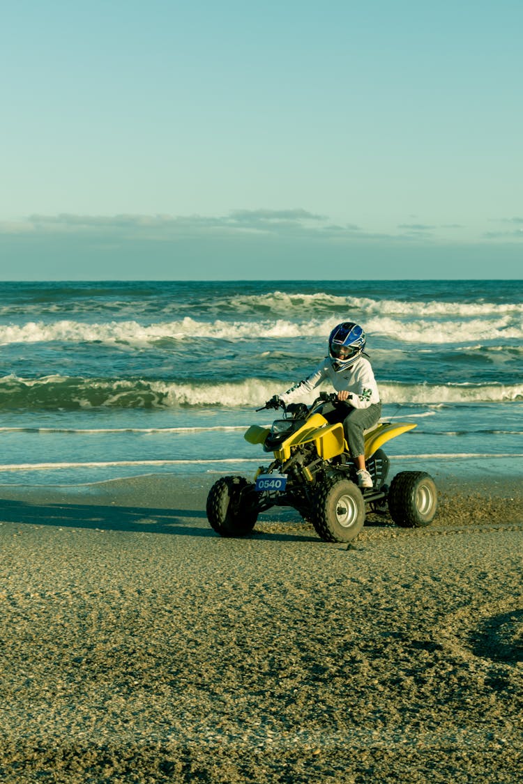 A Person Riding An Atv On The Beach