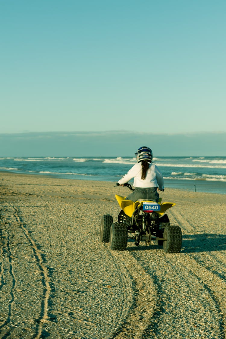 A Person Riding An Atv On The Beach