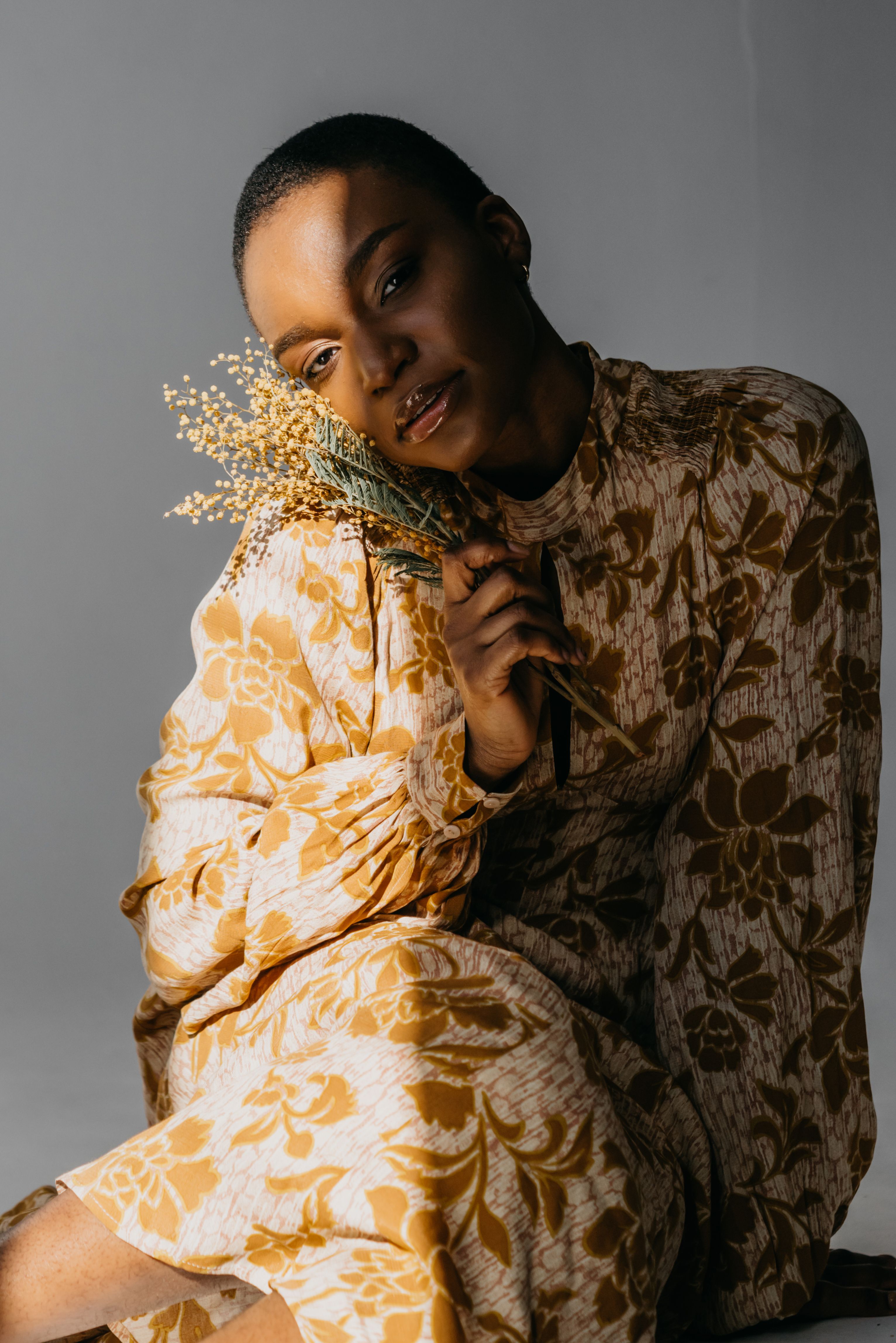 Woman in Floral Print Dress Holding a Bunch of Yellow Flowers · Free ...