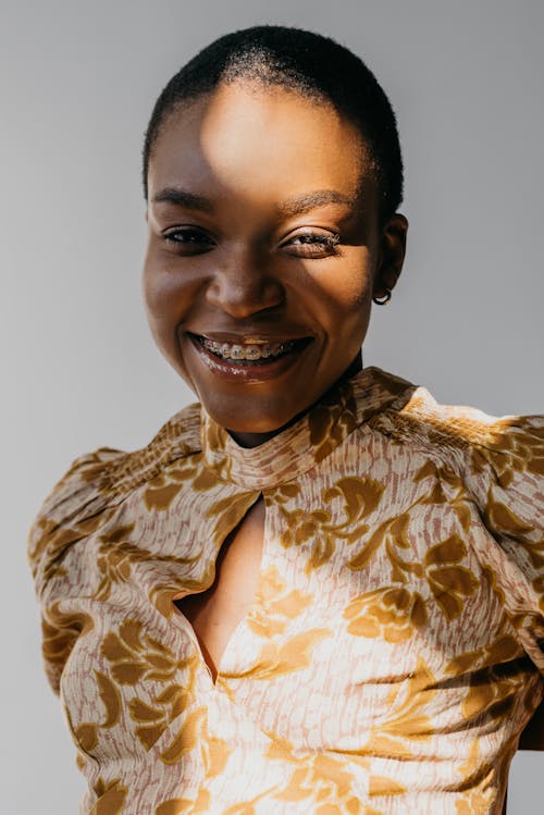 Free A Smiling Woman in Floral Dress Stock Photo