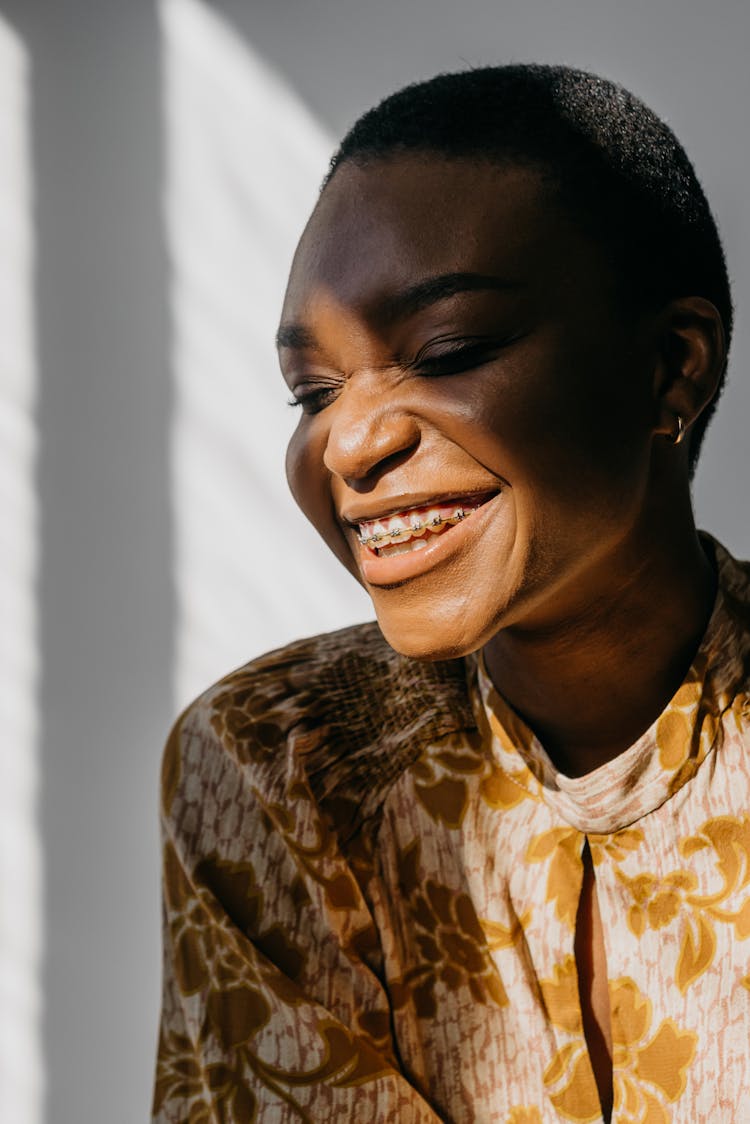 A Woman Smiling With Braces On Her Teeth