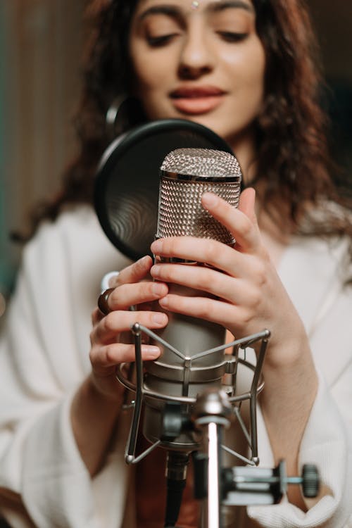Woman Singing in a Recording Studio