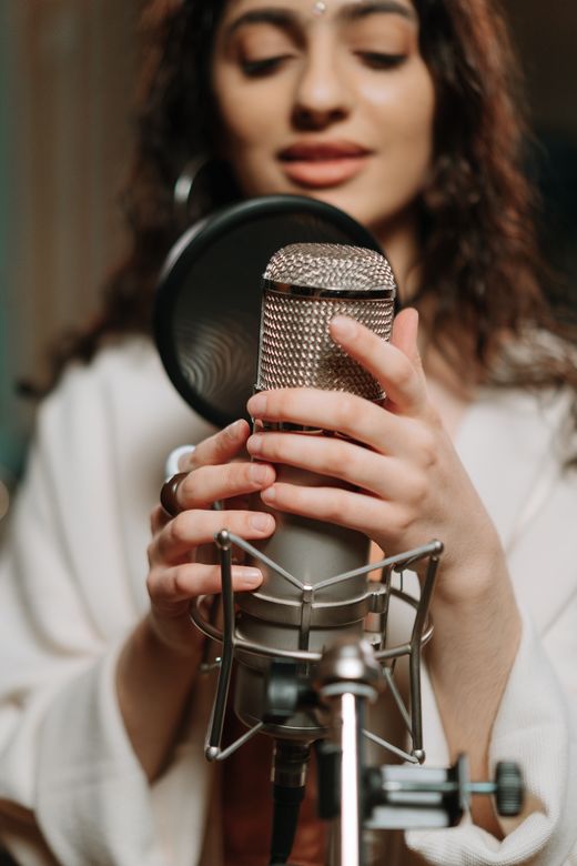 Singer recording in a studio — photo by cottonbro studio on Pexels