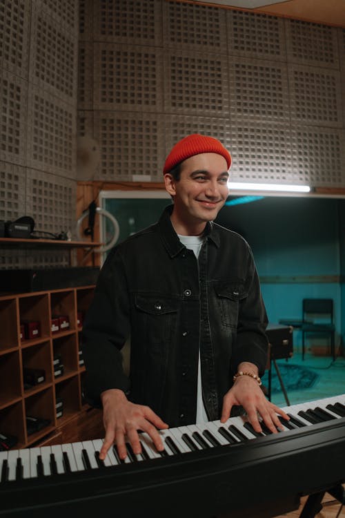 A Man Playing Piano inside a Music Studio