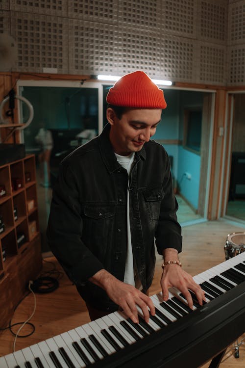 A Man Playing Piano inside a Music Studio