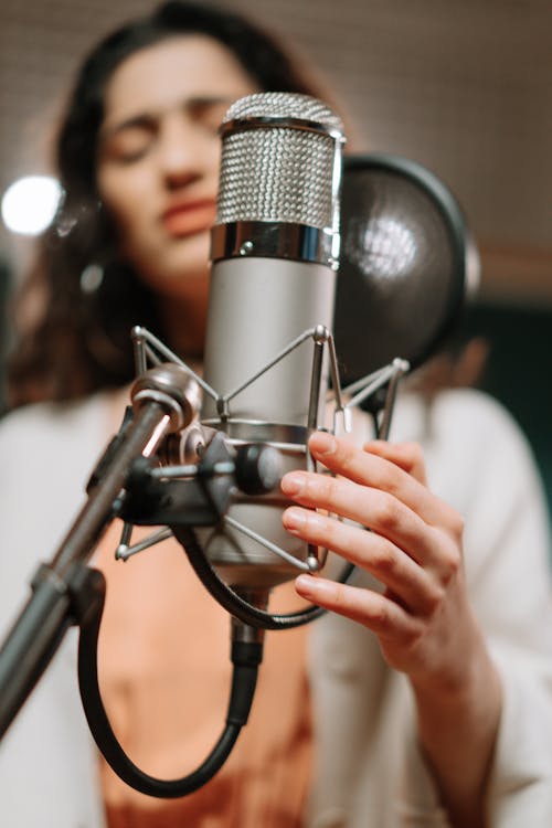 Free Woman Singing in a Recording Studio Stock Photo