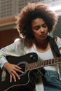 Woman in Black Tank Top Playing Acoustic Guitar