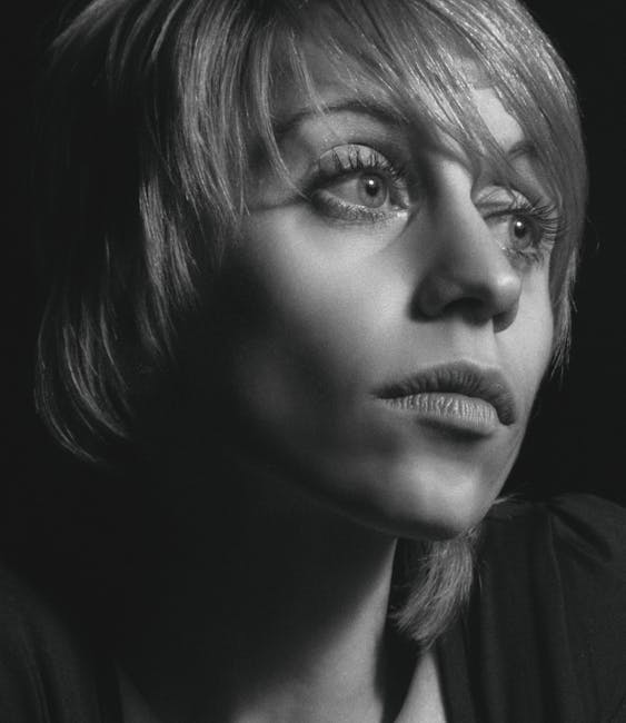 Emotive black-and-white portrait of a woman with short hair, captured in Kyiv.