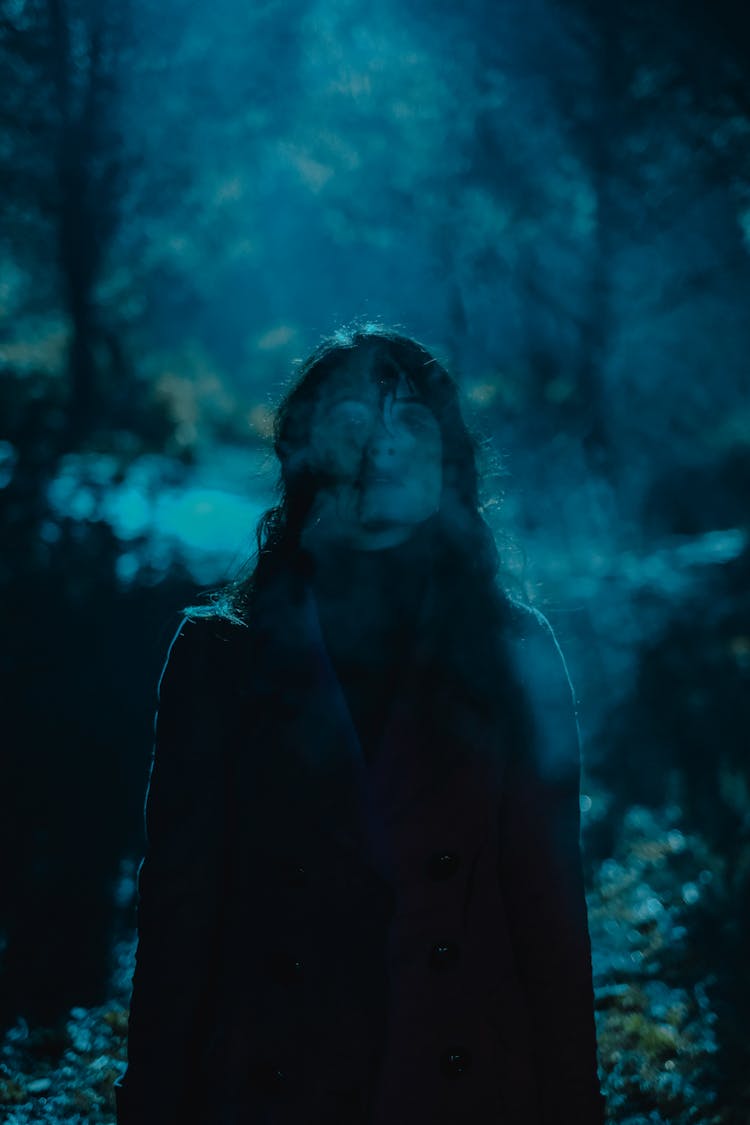 Ghost Of Woman Standing Among Trees At Night