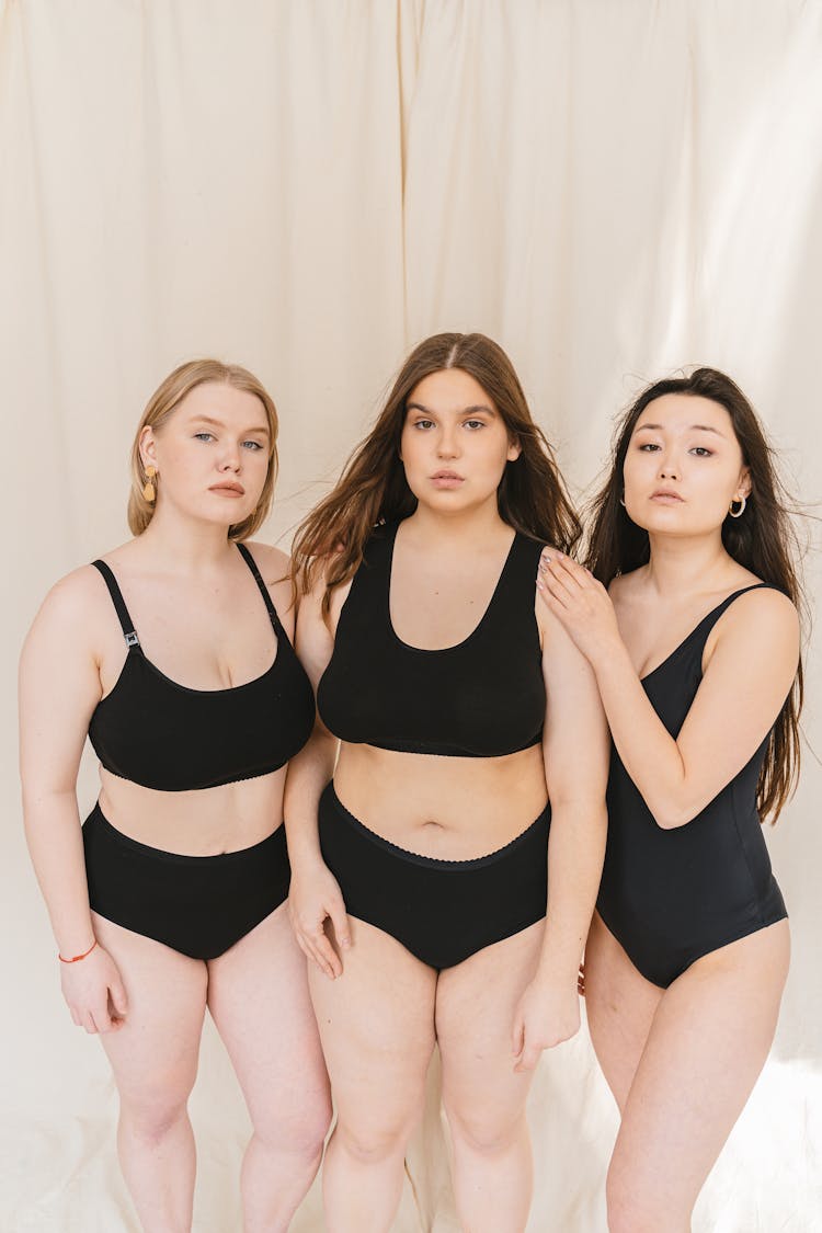 Three Women In Black Swimsuit Standing