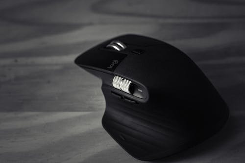 Black and white of contemporary convenient game mouse with various buttons on table