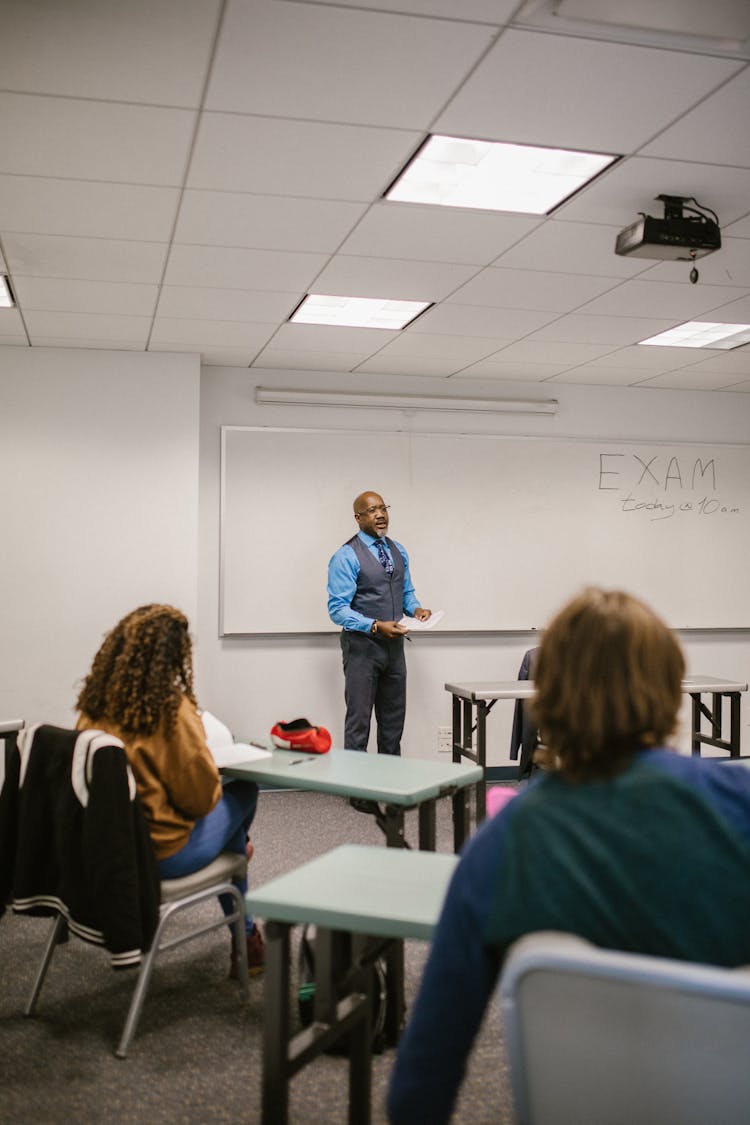 Teacher Discussing His Lesson To His Students