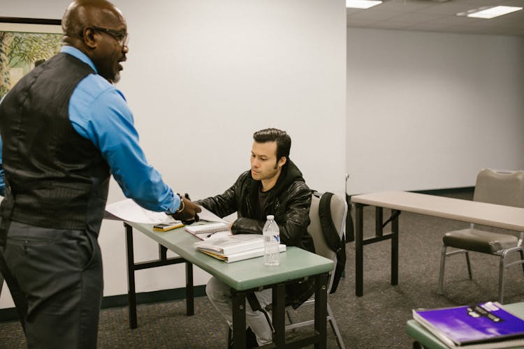 Teacher Giving The Test Result To His Student