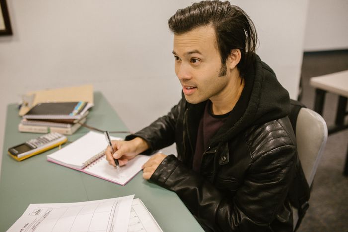 Student practising with a calculator and notebook