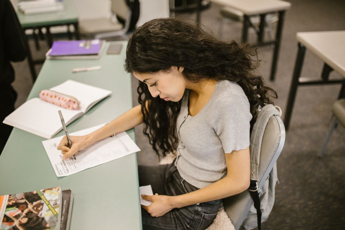 Student Is Cheating Student Cheating During an Exam · Free Stock Photo