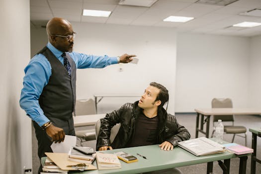 A teacher reprimands a student in a classroom, highlighting issues of academic integrity.