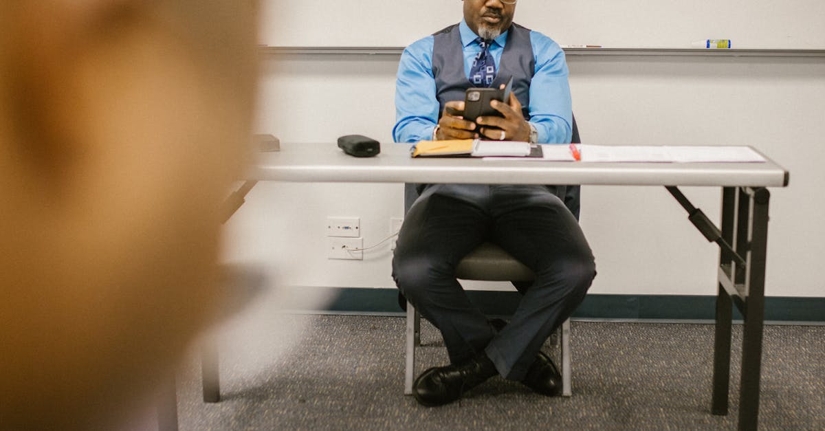 Photo by RDNE Stock project Professor monitors exam while seated in a university classroom setting.