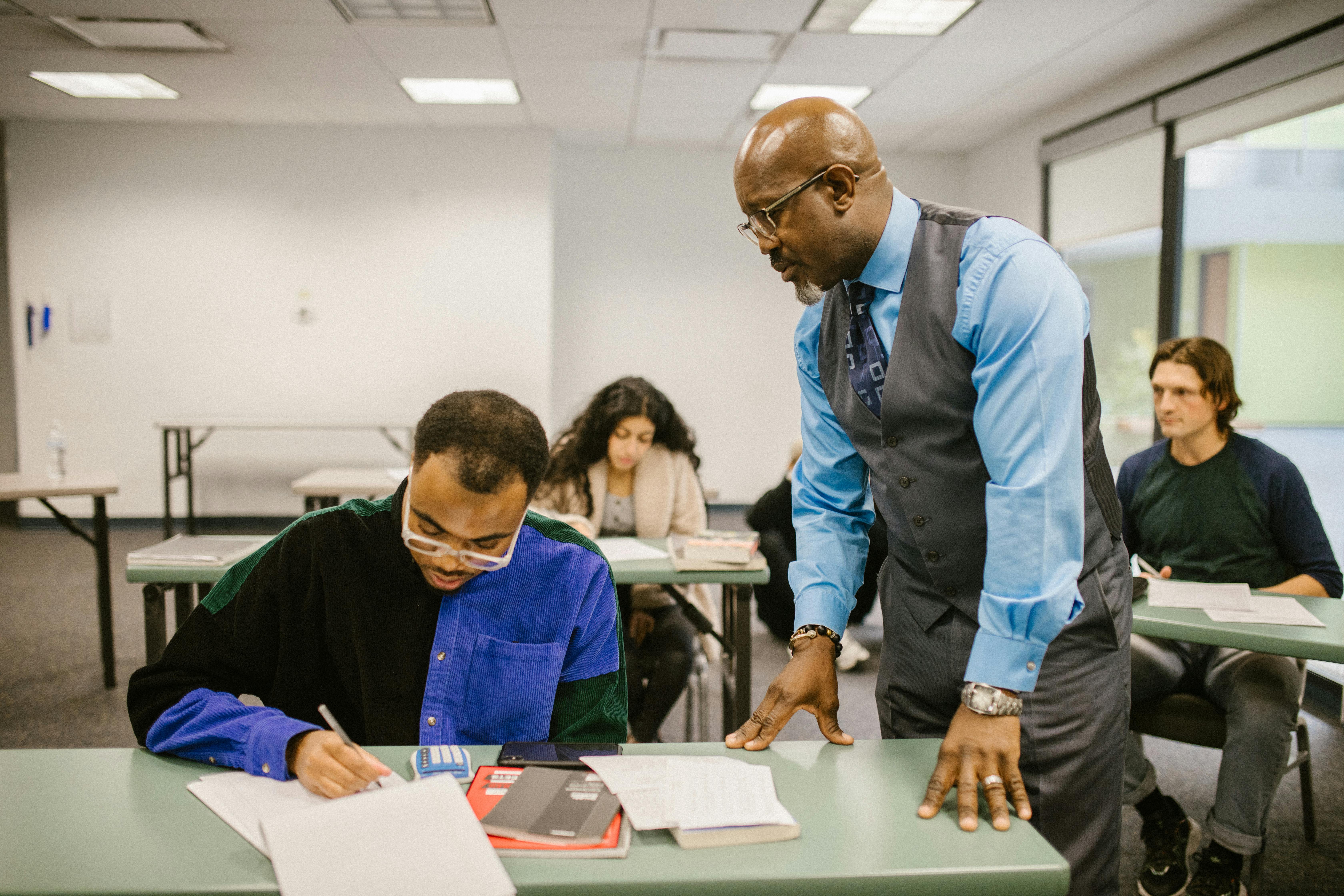 teacher proctoring his students during an examination