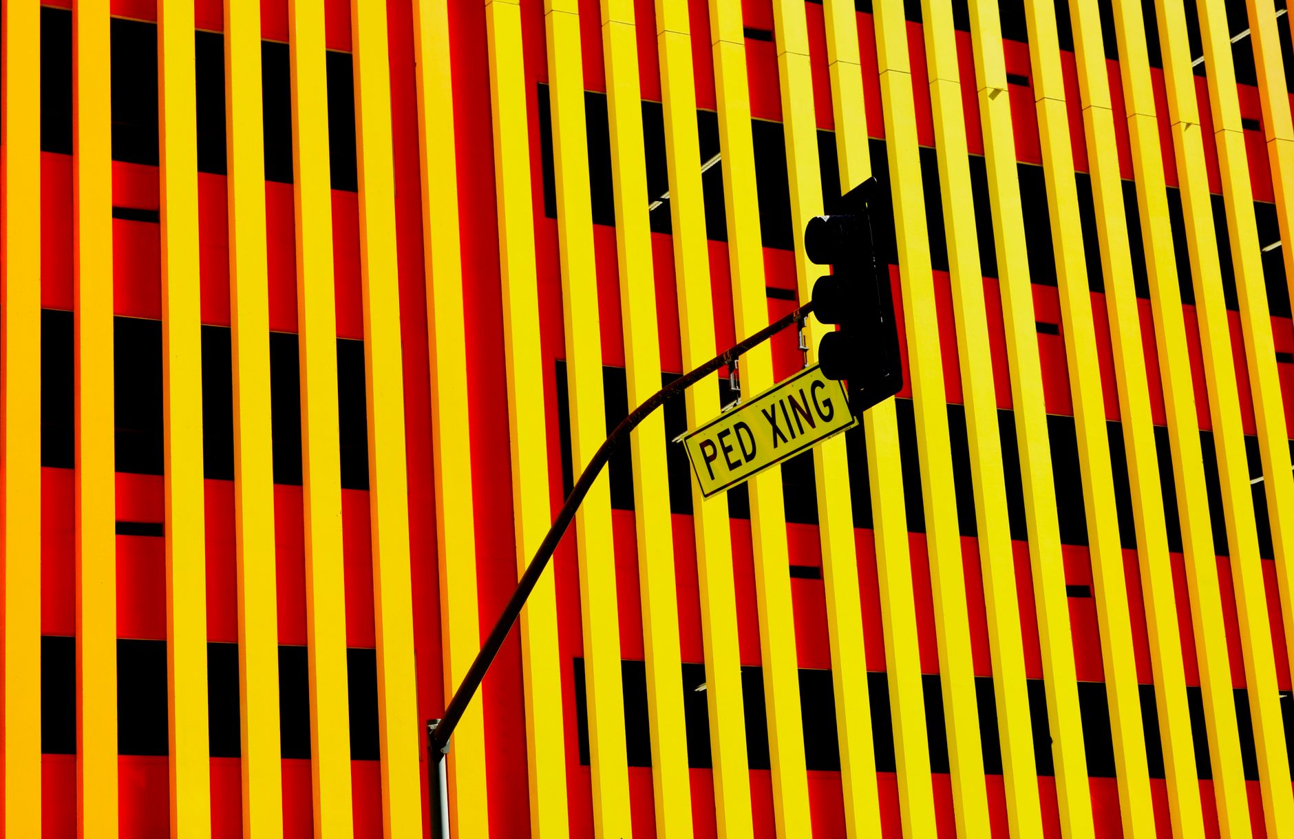 Colorful urban street scene with traffic light and 'PED XING' sign in Los Angeles.