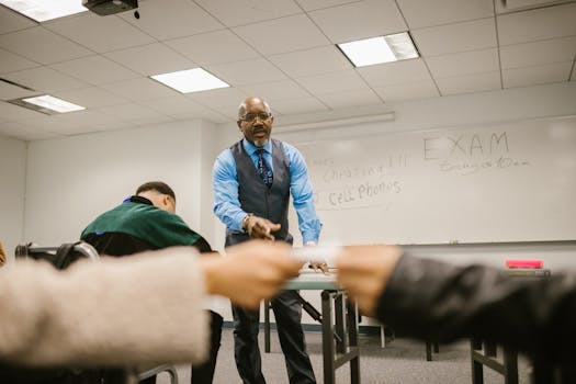 Students interacting with a teacher in a classroom during an exam, focusing on academic integrity.