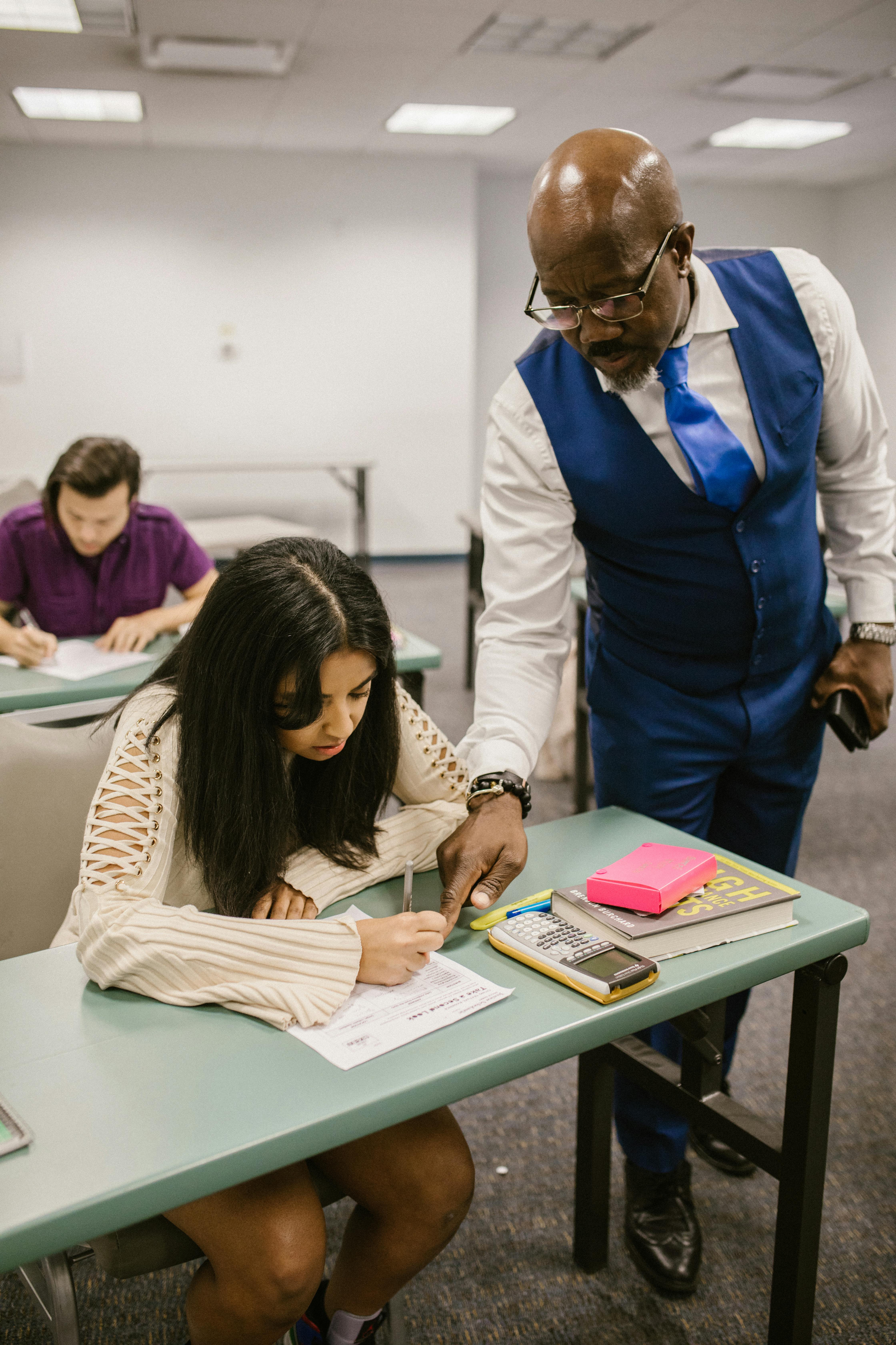 teacher proctoring his students during an examination