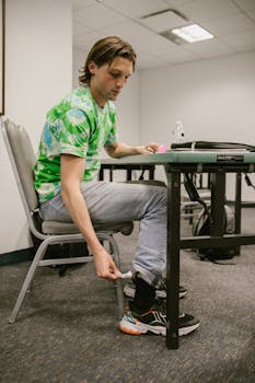 A student discreetly hides a cheat sheet during a classroom exam setting.