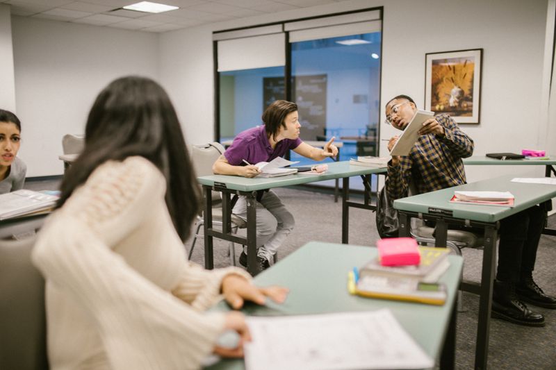 Adult learners collaborating in a statistics class