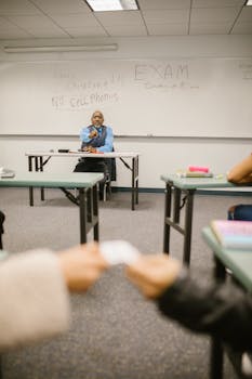 Students discreetly exchange a cheat sheet during a classroom exam.