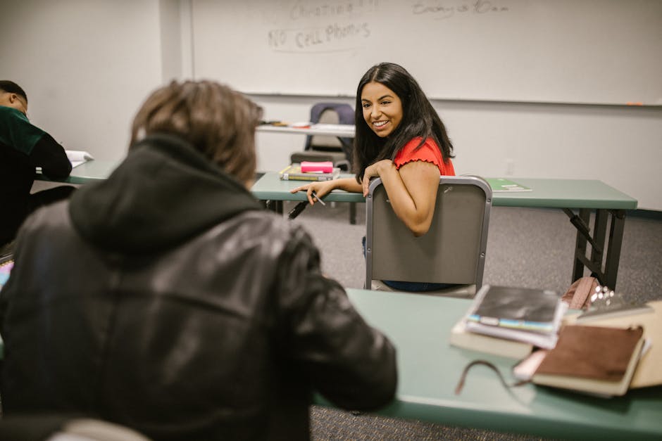 What Sleep Research Reveals About Bamboo vs Cotton Students chatting during a break in a college classroom, surrounded by study materials and friendly atmosphere.