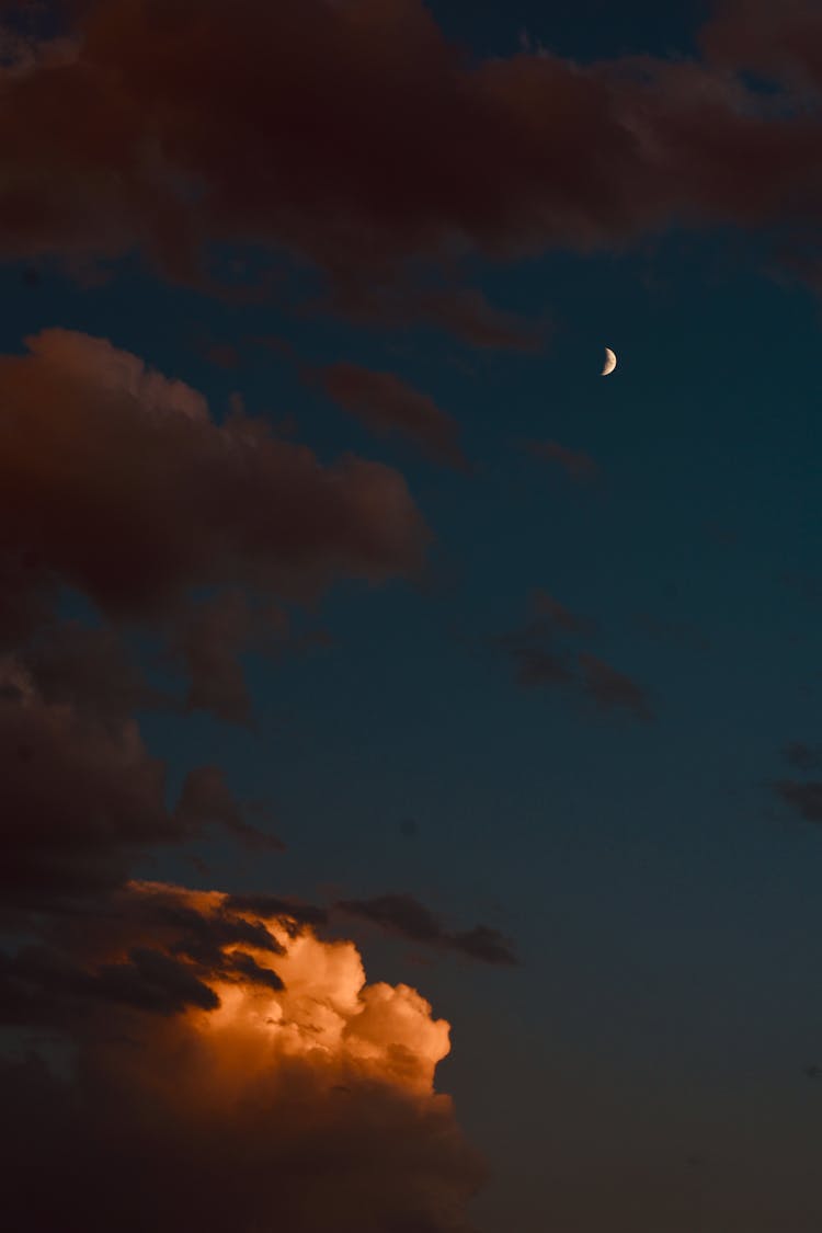 Moon In Dark Cloudy Sky At Sundown