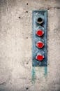Shabby metal components of city fire suppression system on aged concrete wall in daytime