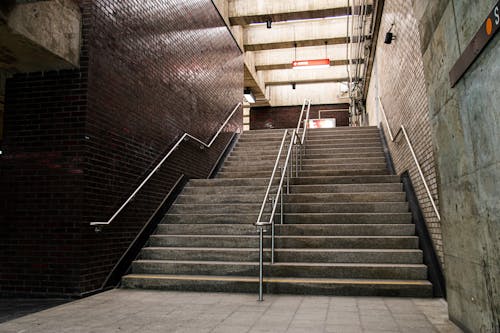 Gray Concrete Staircase With Stainless Steel Railings