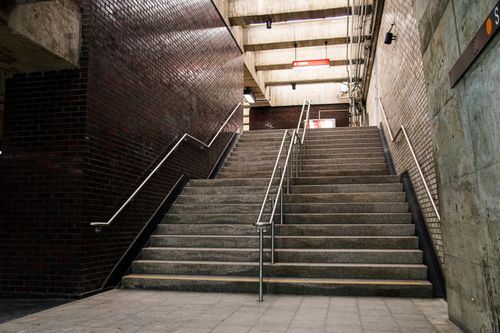 Free Empty concrete staircase with handrails inside a Montréal subway station. Stock Photo