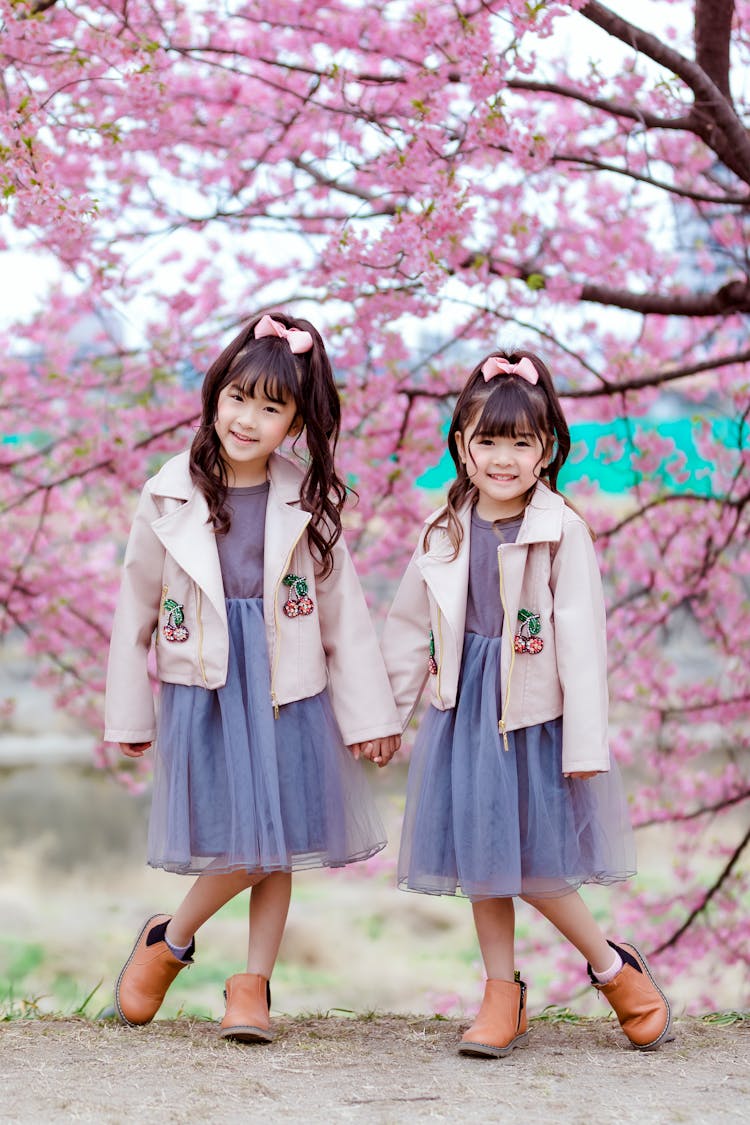 Pretty Little Girls In Blazer Standing Near The Tree