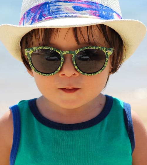 Boy in Green Tank Top Wearing Sunglasses and Hat