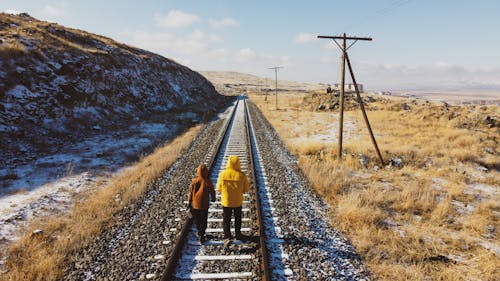 Free Two People Walking on the Railroad Stock Photo