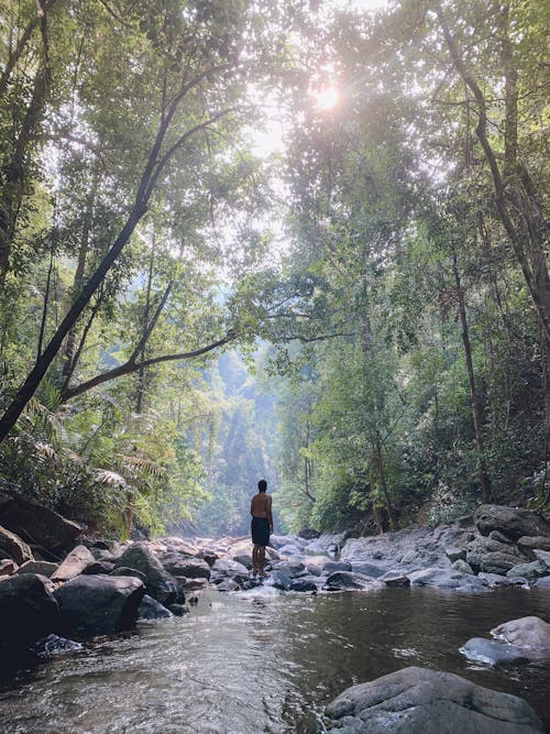 A Person Standing on Rocky in River