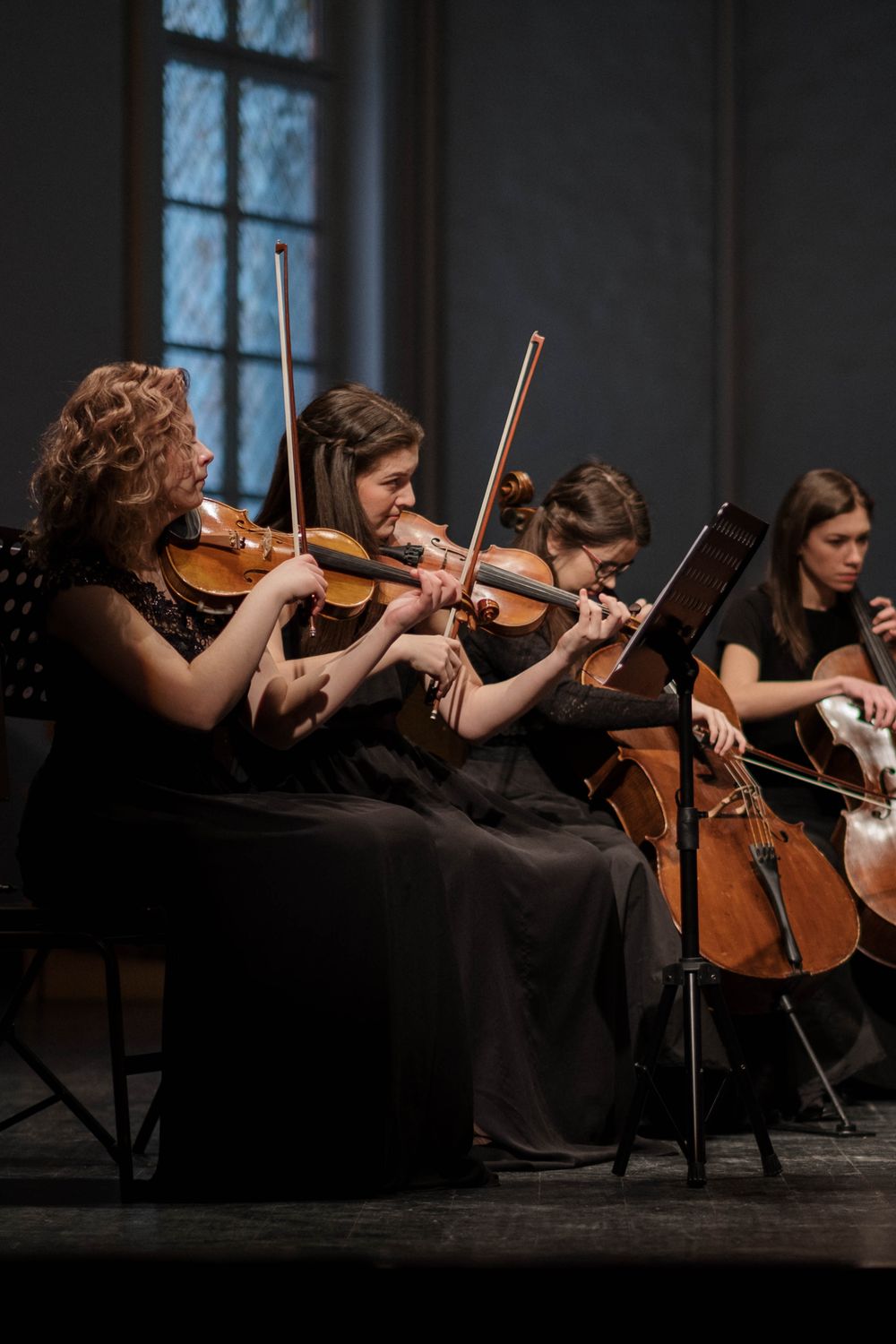 String players performing together indoors