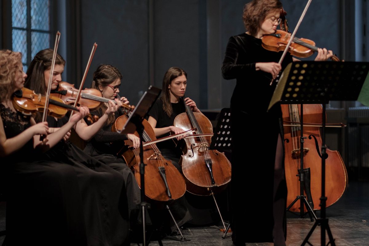 Musicians performing classical music with violins and cellos